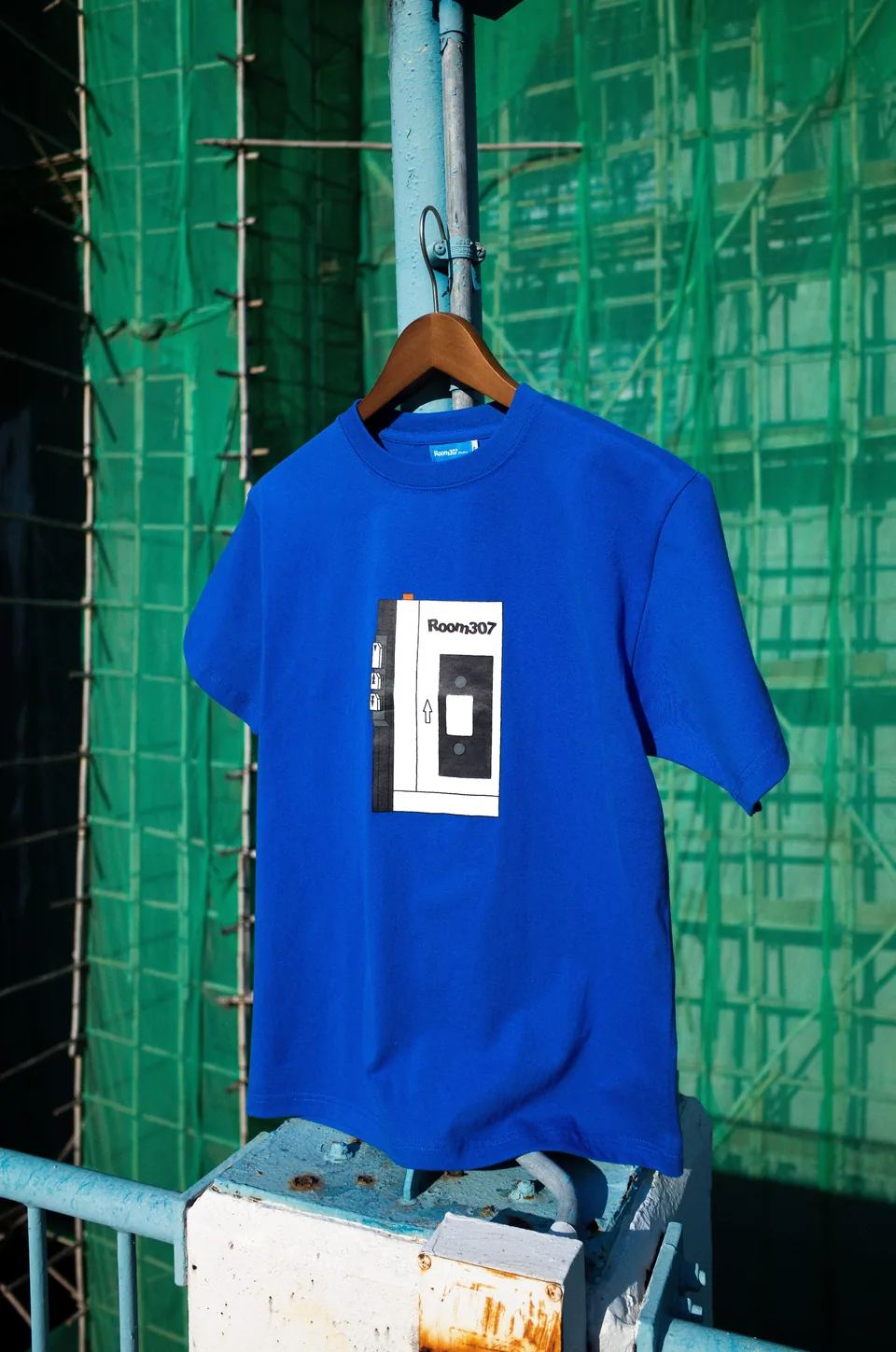 Model wearing the blue Room307 Cassette Player T-shirt.