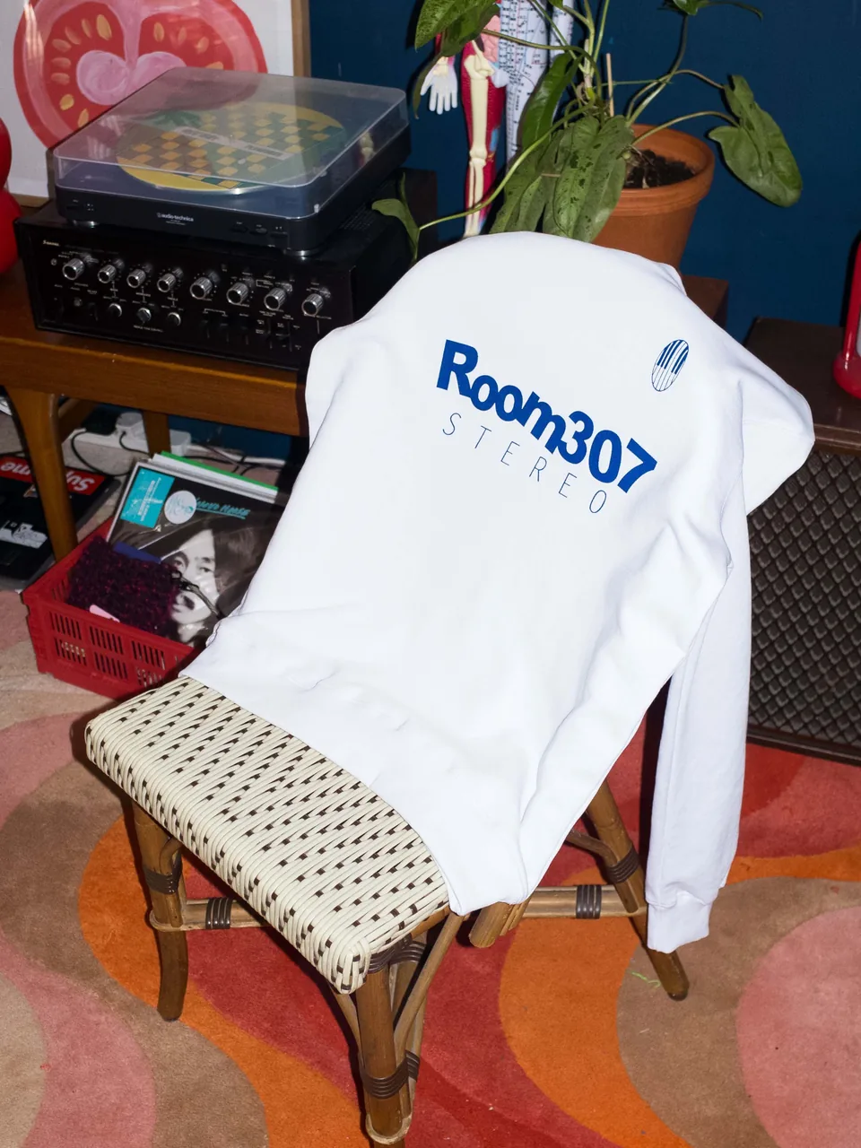 Model wearing the white Room307 Classic long-sleeve shirt.